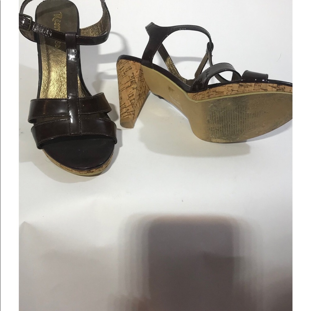 Brown patent leather cork heeled shoes.